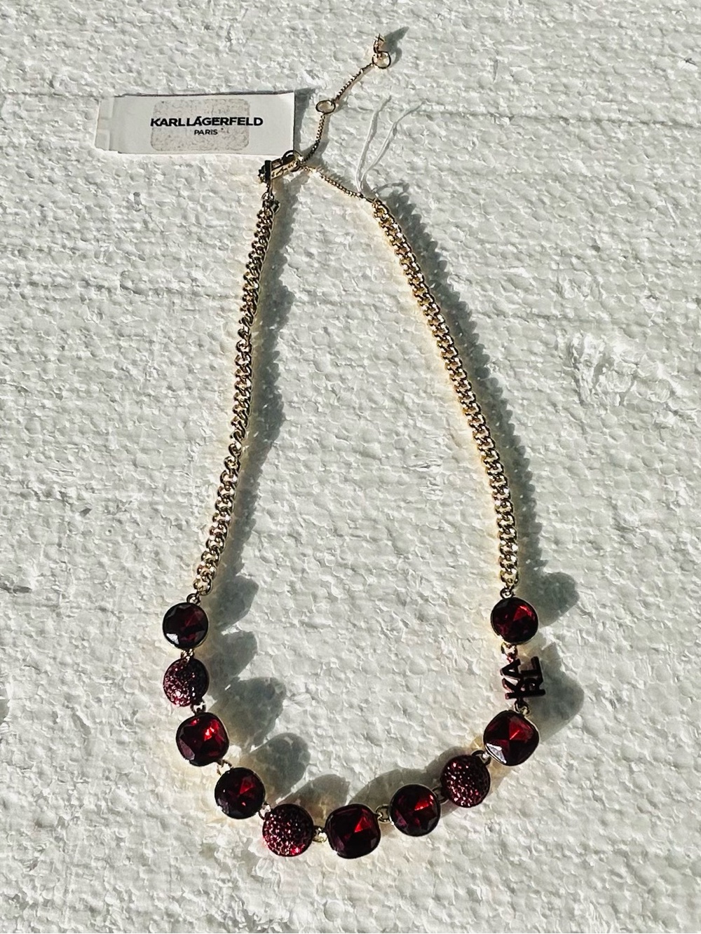 Karl largerfeld gold necklace with red gem stones & logo